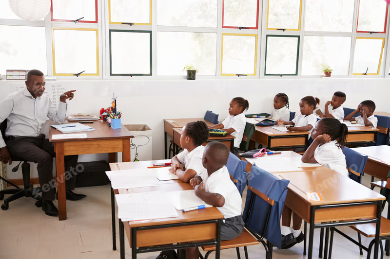 A teacher working with pupils in a bright Nigerian classroom